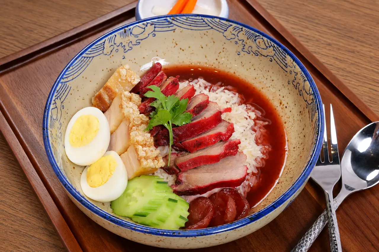 Moo Dang & Moo Krob rice bowl with barbecue pork, crispy pork belly, Chinese sausage and egg.